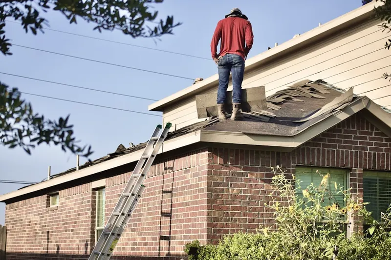 Professional roofer working on a residential roof in Haltom City